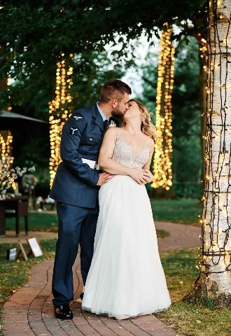 bride and groom share a kiss whilst posing for their wedding photography at the crazy bear in stadhampton
