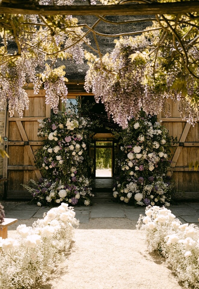 Outdoor Barn Wedding Ceremony at Tythe in Oxfordshire with Floral Arch.