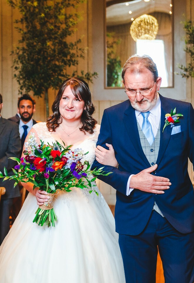 bride walking down aisle with father
