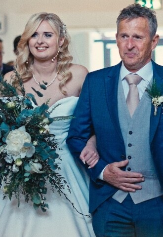 bride and father of the bride walking down the aisle