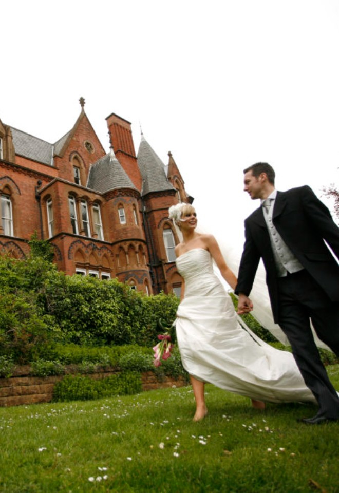 Bride and groom walk next to their wedding venue, Bestwood Lodge