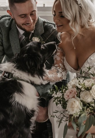Bride and groom with dog at Auchen Castle - a dog-friendly castle wedding venue in Scotland