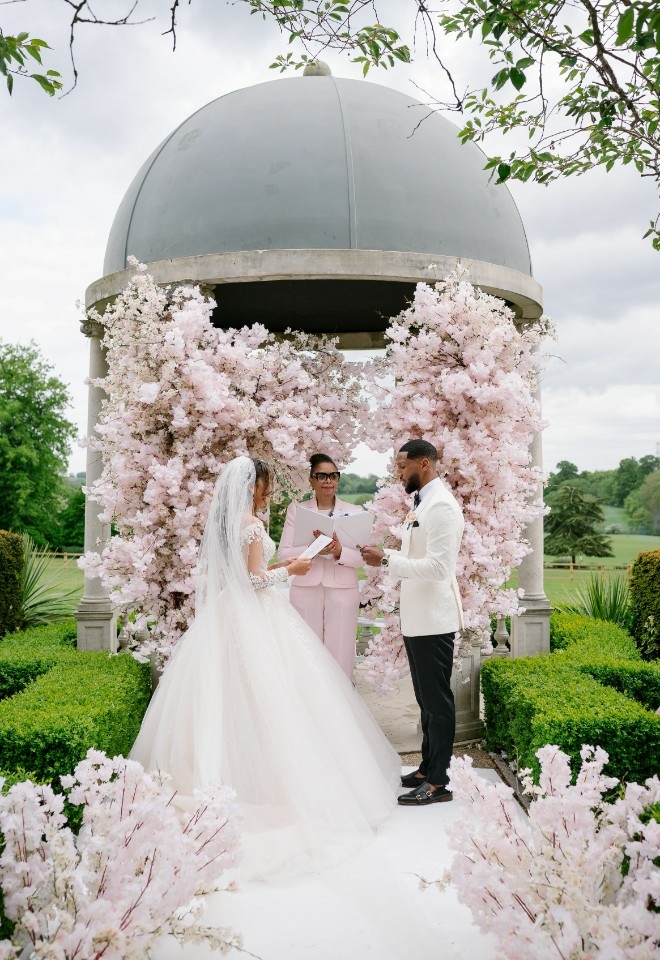 Jennifer Patrice, an experienced Independent Celebrant, with a happy couple on their wedding day, delivering an authentic, joyful, and personalised ceremony in a beautiful setting.
