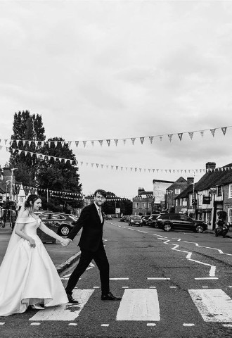 Black and white photo of wedding couple on zebra crossing in Old Amersham, Buckinghamshire