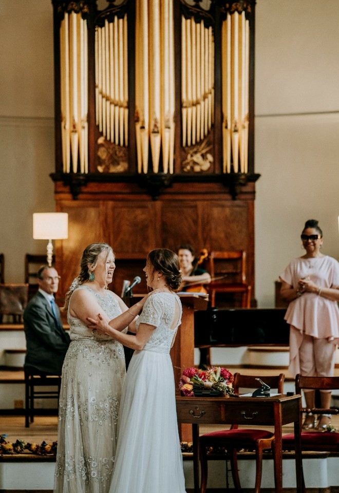 Jennifer Patrice, an experienced Independent Celebrant, with a happy couple on their wedding day, delivering an authentic, joyful, and personalised ceremony in a beautiful setting.