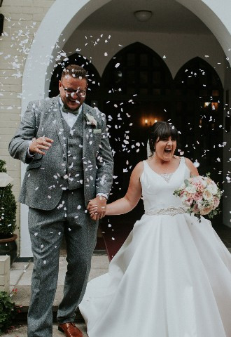 Bride and groom being showered in confetti at Glen Yr Afon House Hotel