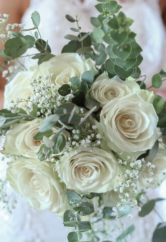Wedding floral bridal bouquet with white roses, babies breath and eucalyptus leaves