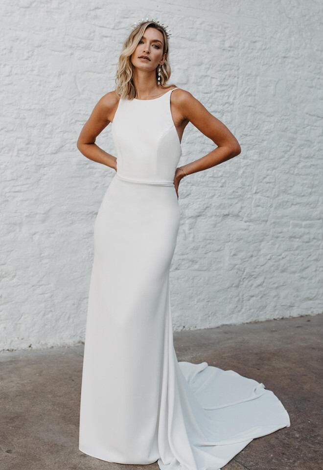 High neck wedding dress with open back and column skirt. Available at Your Story Bridal, Marlow.