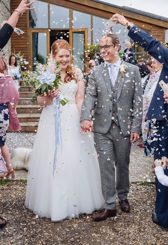Bride and groom being showered in confetti at Rosedew Farm, Vale of Glamorgan