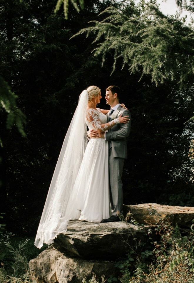 Couple photographed on rock structure in the woodland