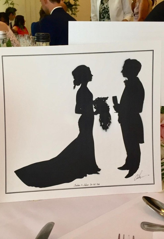 Silhouettes of bride and groom on table display
