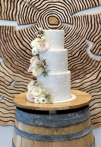 White 3 tiered wedding cake covered in pearls & duchess roses design & made by Gallery Cakes in Wantage, Oxfordshire