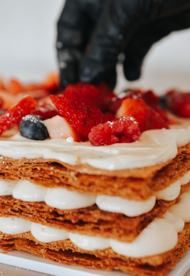 Close-up of an Italian Millefoglie wedding cake by Oxfordshire-based Dolce Lusso Cakes, with crisp pastry, cream and fresh berries.
