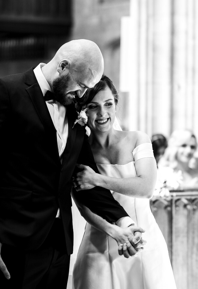bride and groom hugging in church
