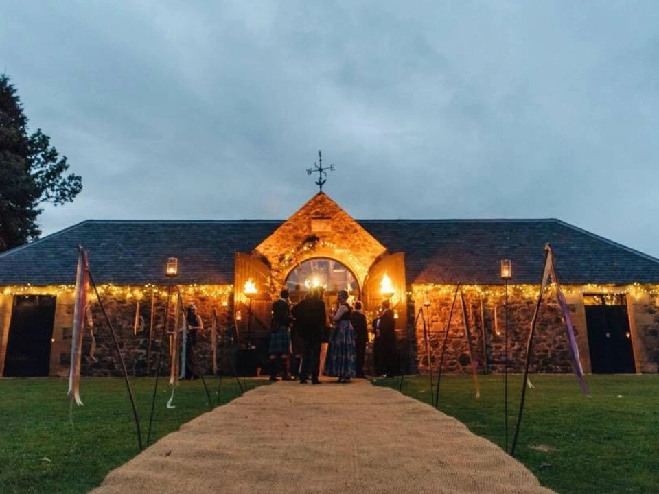 Exterior of Barn venue in the dark with lights 