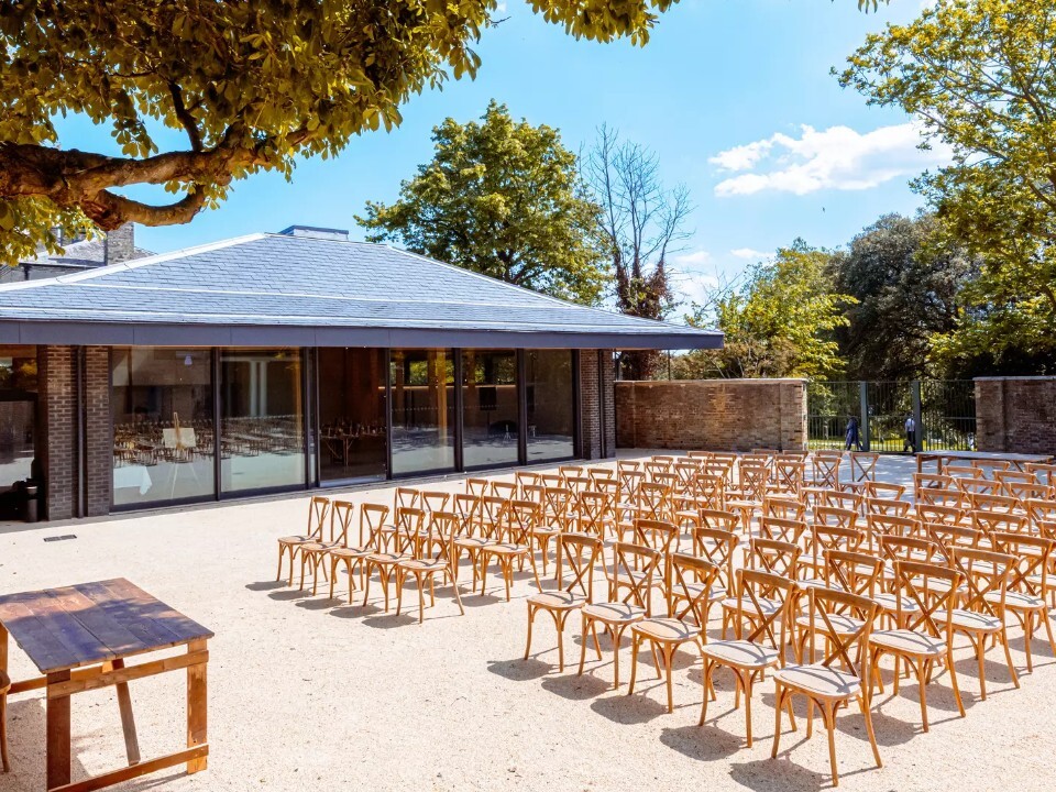 Exterior of Barn venue in daylight with chairs set up for ceremony
