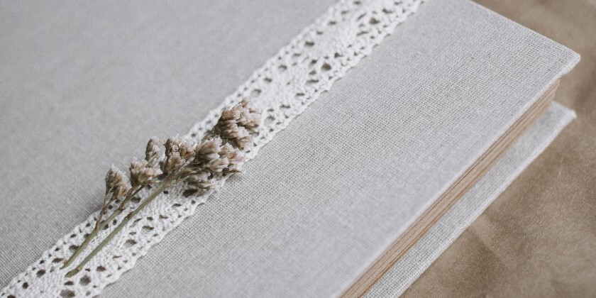 Wedding photo album with linen cover and lace detail.