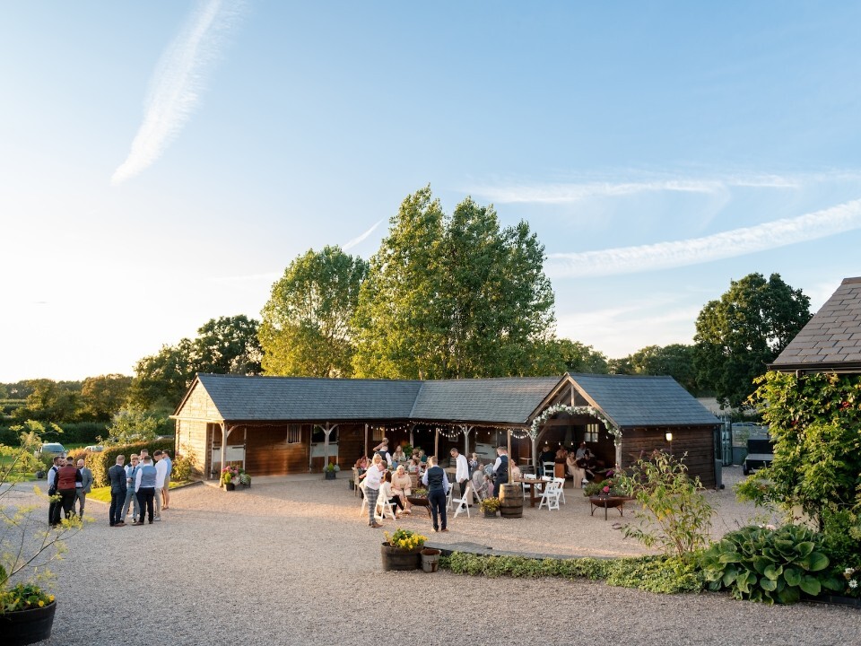 Exterior of Barn venue in daylight with guests