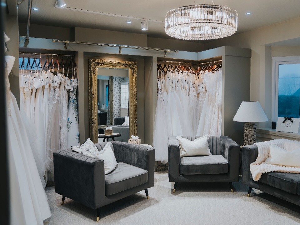 Private suite in bridal boutique with sofas and wedding dresses at TDR Bridal Birmingham