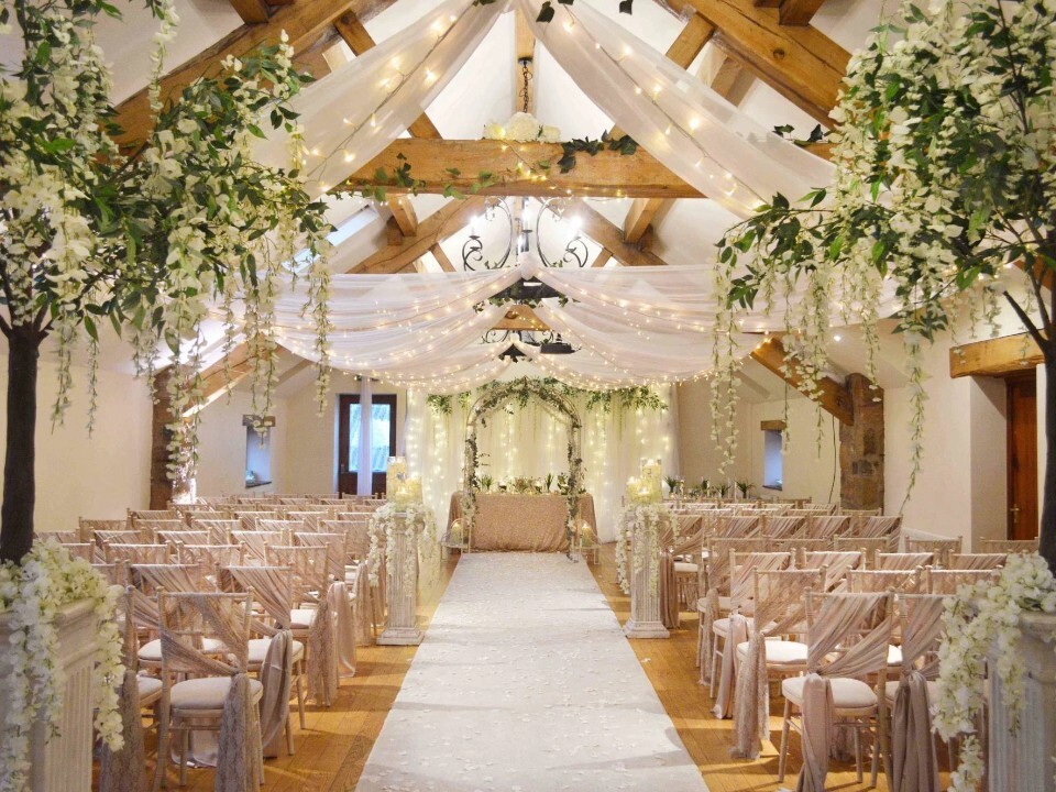 Inside of a barn venue, looking at a ceremony area