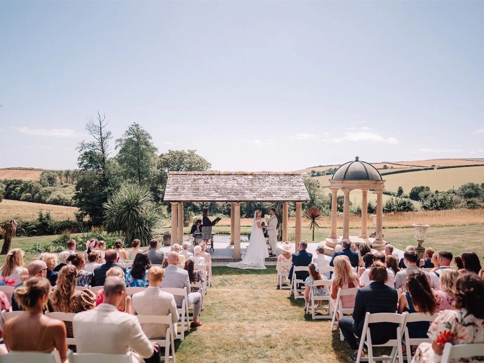 Bride and groom getting married during outdoor wedding ceremony in Cornwall
