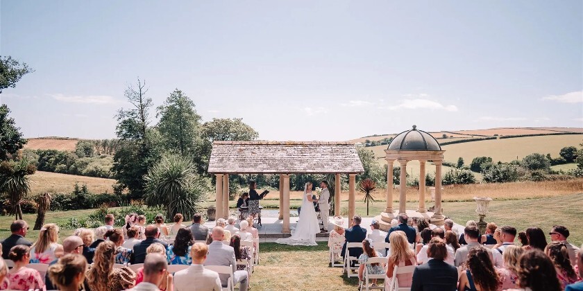 Bride and groom getting married during outdoor wedding ceremony in Cornwall
