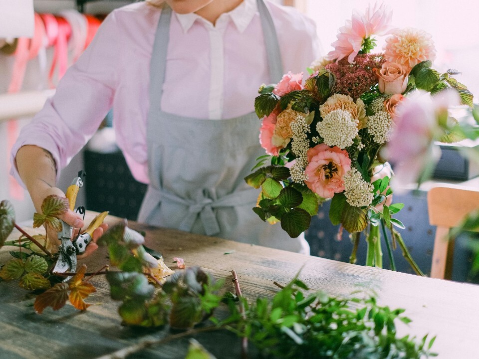 Wedding florist arranging a bouquet