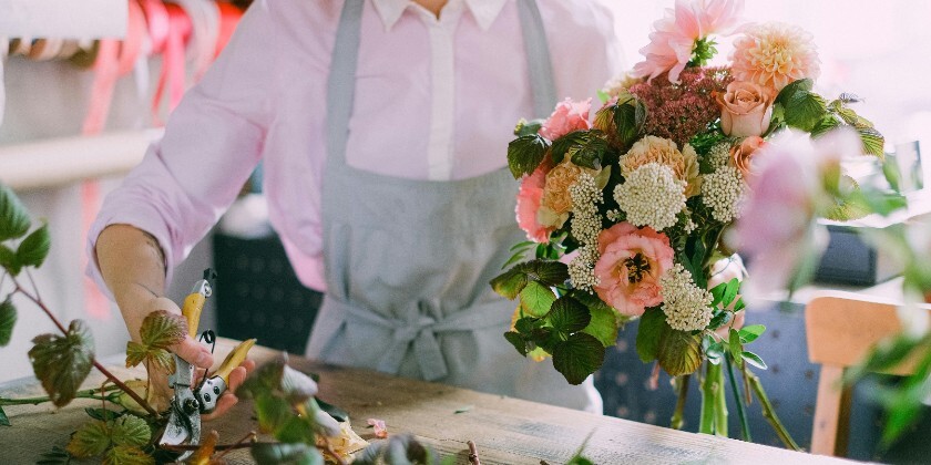 Wedding florist arranging a bouquet