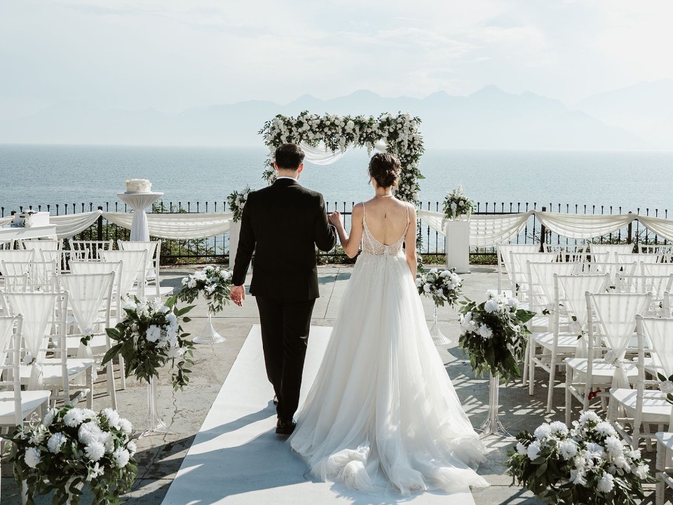 Bride and groom walking down the aisle toward their beachfront wedding ceremony