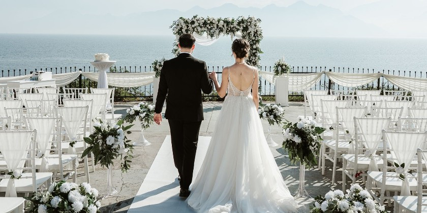 Bride and groom walking down the aisle toward their beachfront wedding ceremony