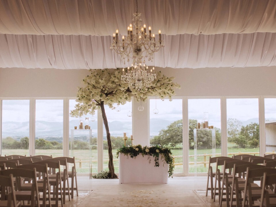 Inside of a barn venue, looking at a ceremony area