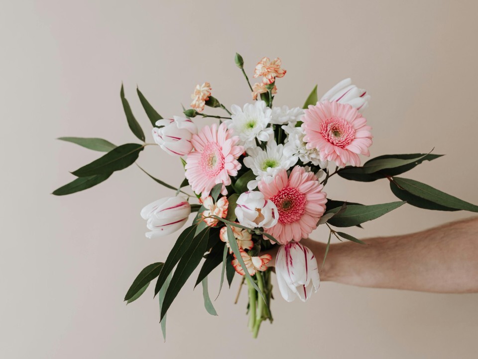 Person holds bouquet of wedding flowers