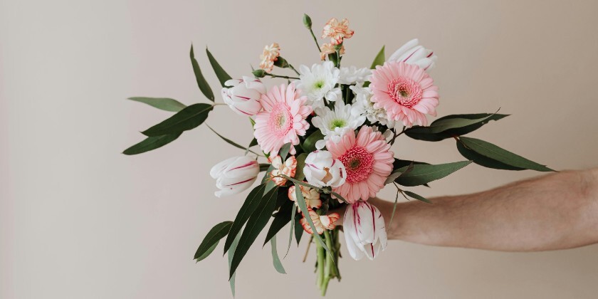 Person holds bouquet of wedding flowers