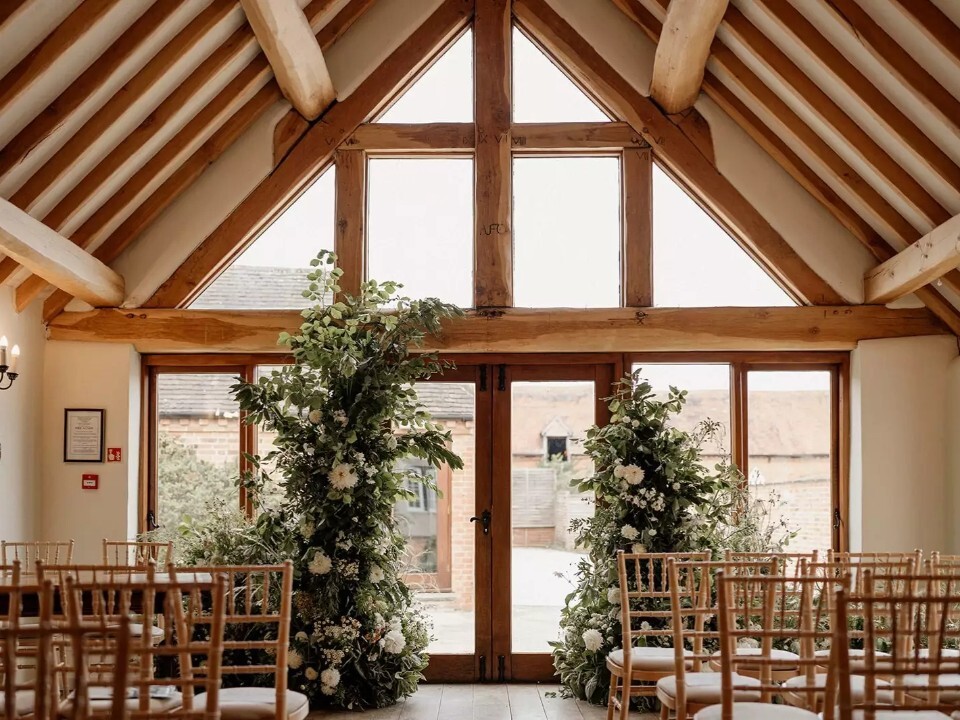 Inside of a barn venue, looking at a ceremony area
