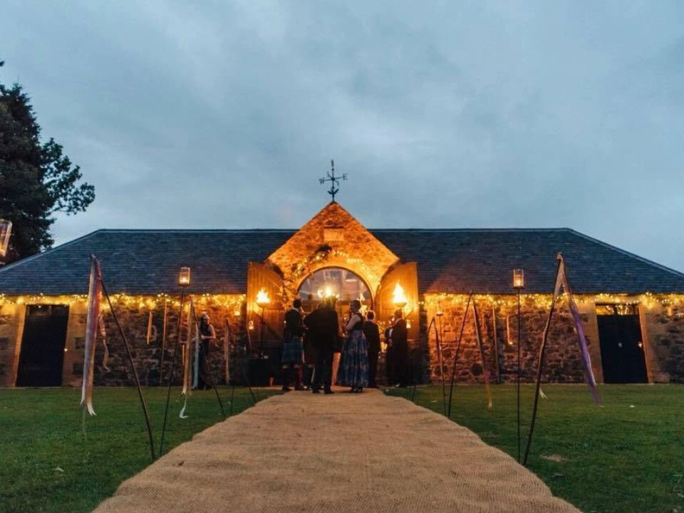Exterior of Barn venue in the dark with lights 