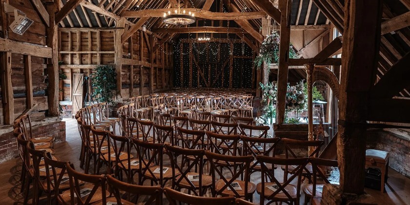 Interior of rustic Hampshire barn being used for a wedding ceremony