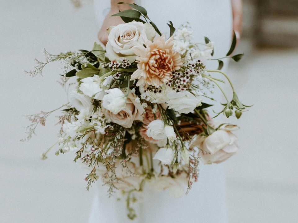 Bride holding wedding bouquet next to her