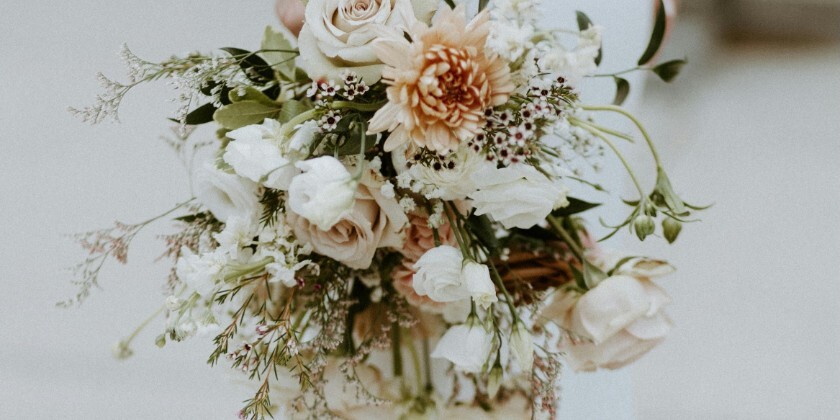 Bride holding wedding bouquet next to her