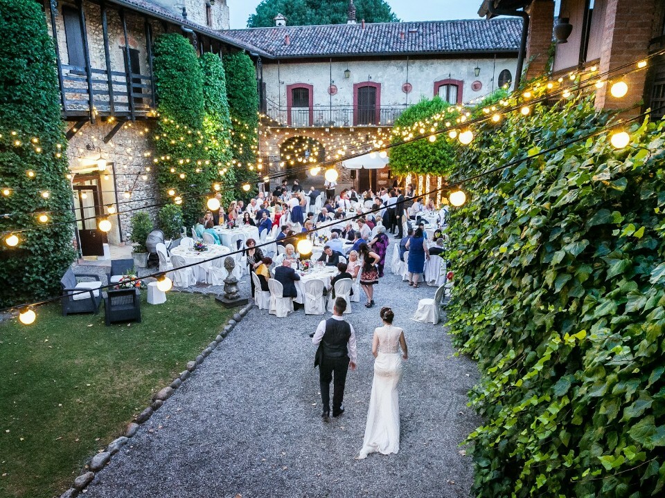 Bride and groom walking towards wedding guests