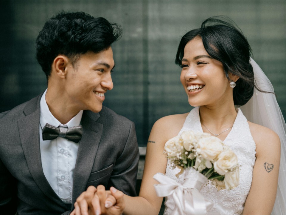 Bride and groom looking at each other and holding hands