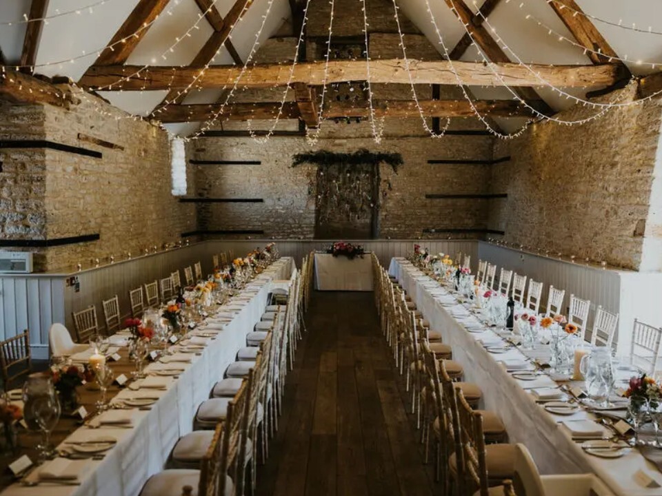 barn wedding breakfast with fairylights and wooden beams