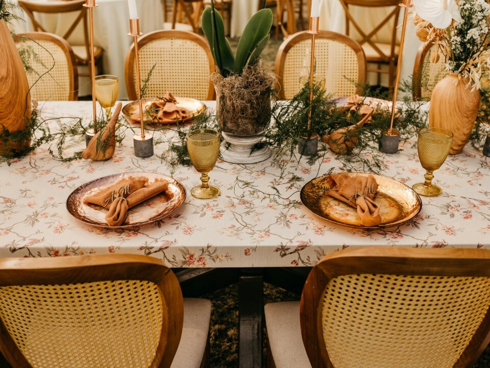 Sustainable wedding tablescape with reusable décor, vintage-style glassware, hired tableware, candles and natural floral styling at a wedding reception.