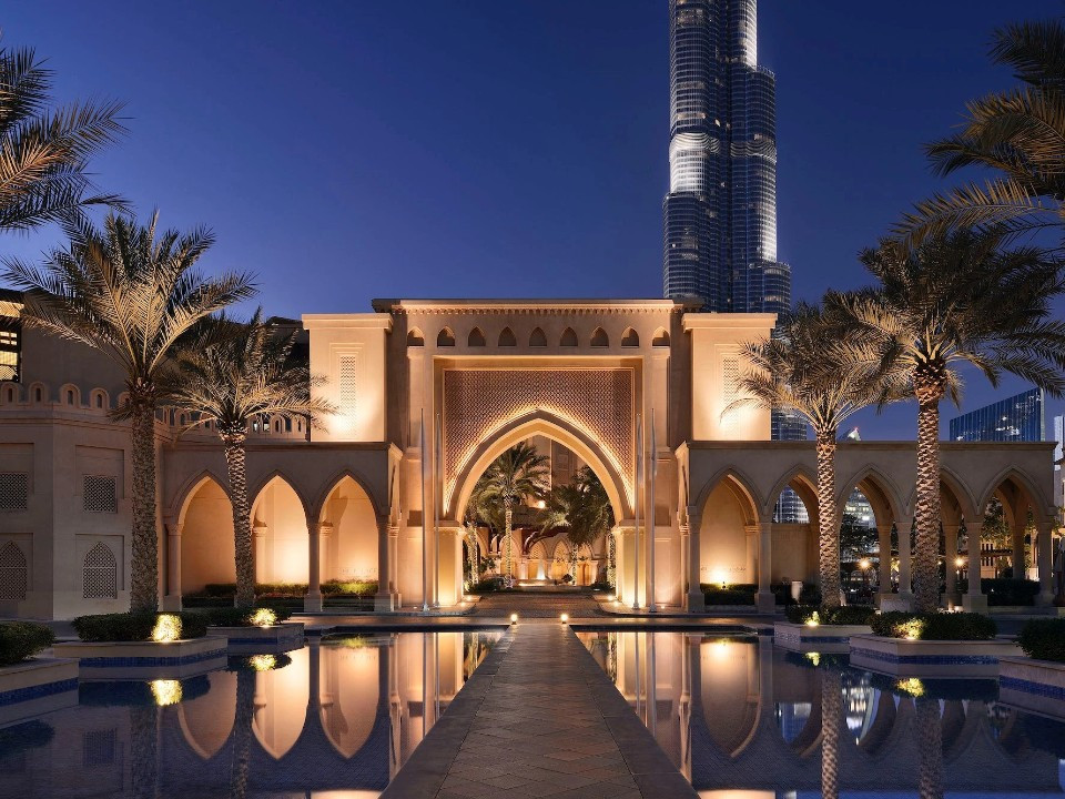 Exterior of luxury Dubai wedding venue, Palace Downtown as sunset overlooking the Burj Khalifa.