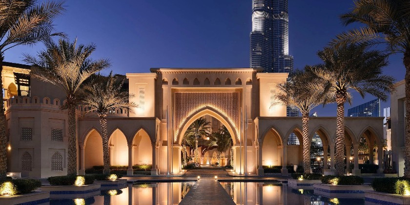 Exterior of luxury Dubai wedding venue, Palace Downtown as sunset overlooking the Burj Khalifa.