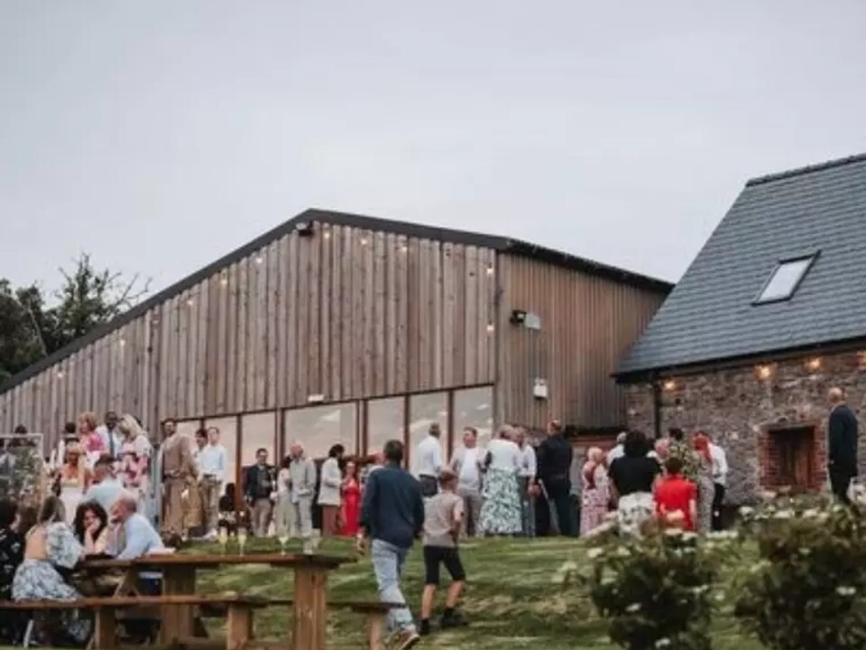 Exterior of Barn venue in daylight with guests