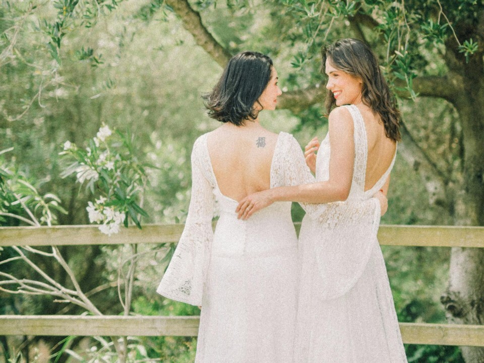 LGBTQ+ couple celebrating at an outdoor wedding venue