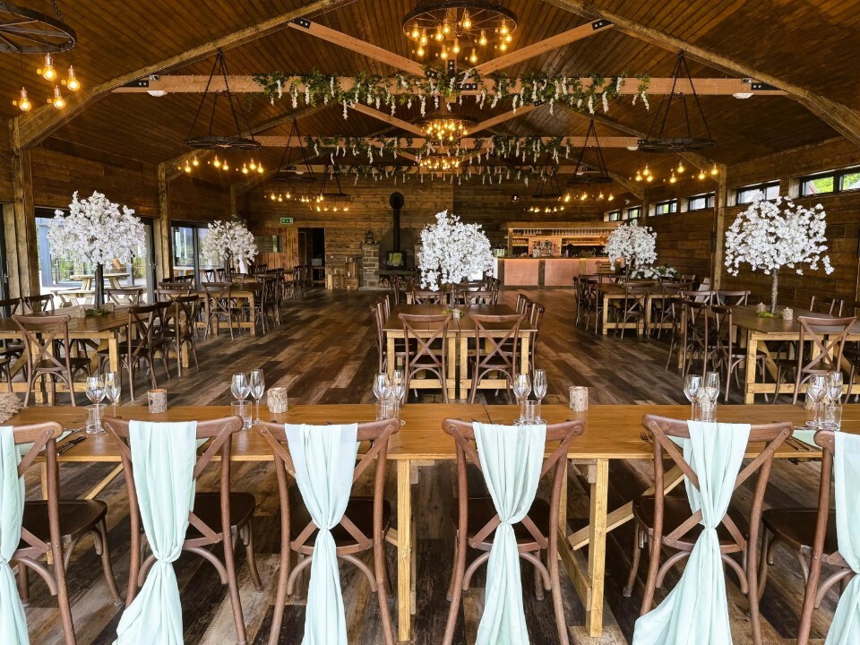 barn table set up with blossom trees 