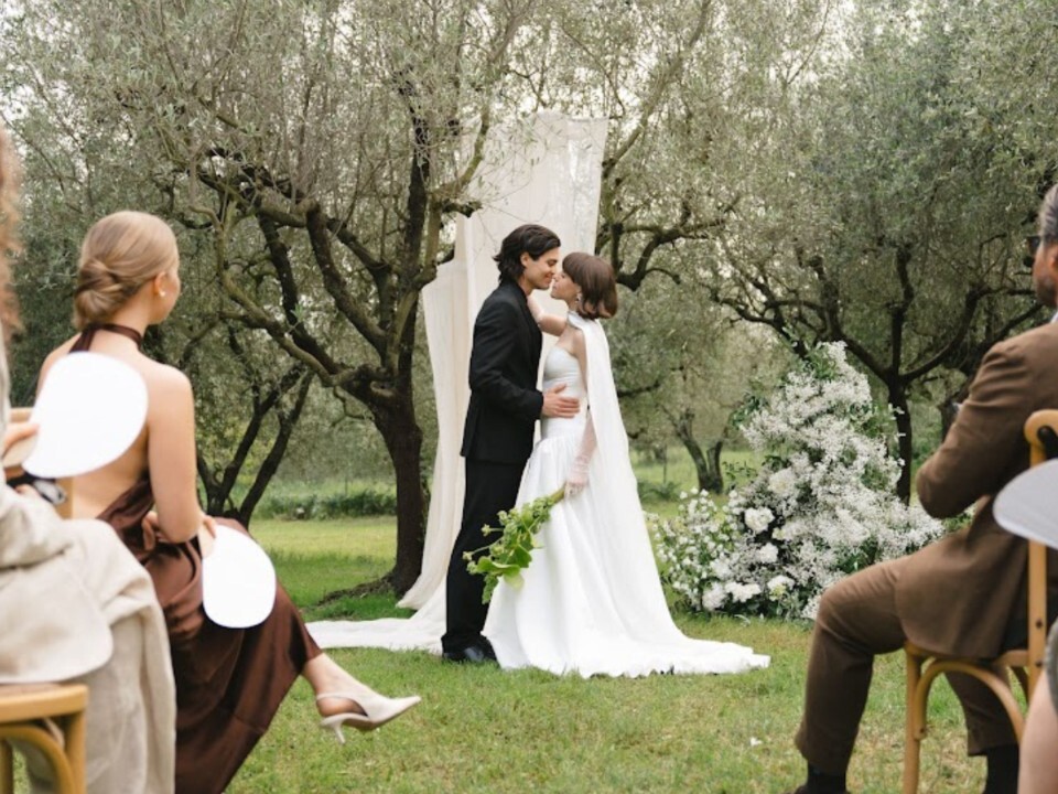Couple exchanging vows during an intimate outdoor wedding ceremony surrounded by close family and friends