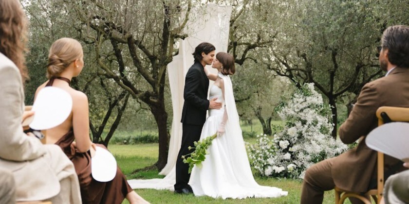 Couple exchanging vows during an intimate outdoor wedding ceremony surrounded by close family and friends