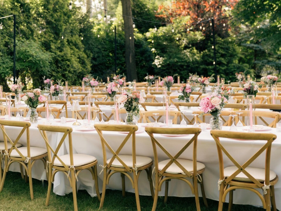 Tables set for an outdoor wedding with alfresco dining.